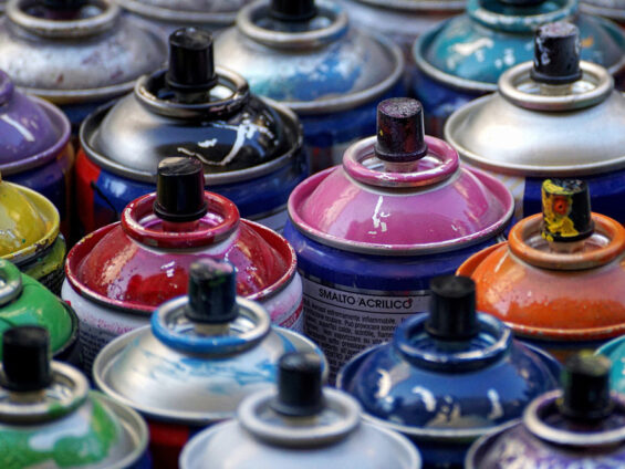 Bombes de peinture aérosols serrées les unes à côté des autres et dont on ne voit que la partie supérieur